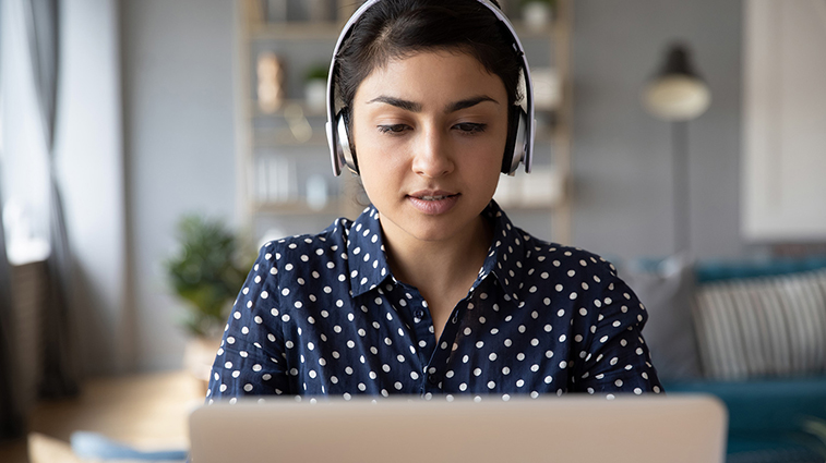 Asian girl in headphones study on laptop