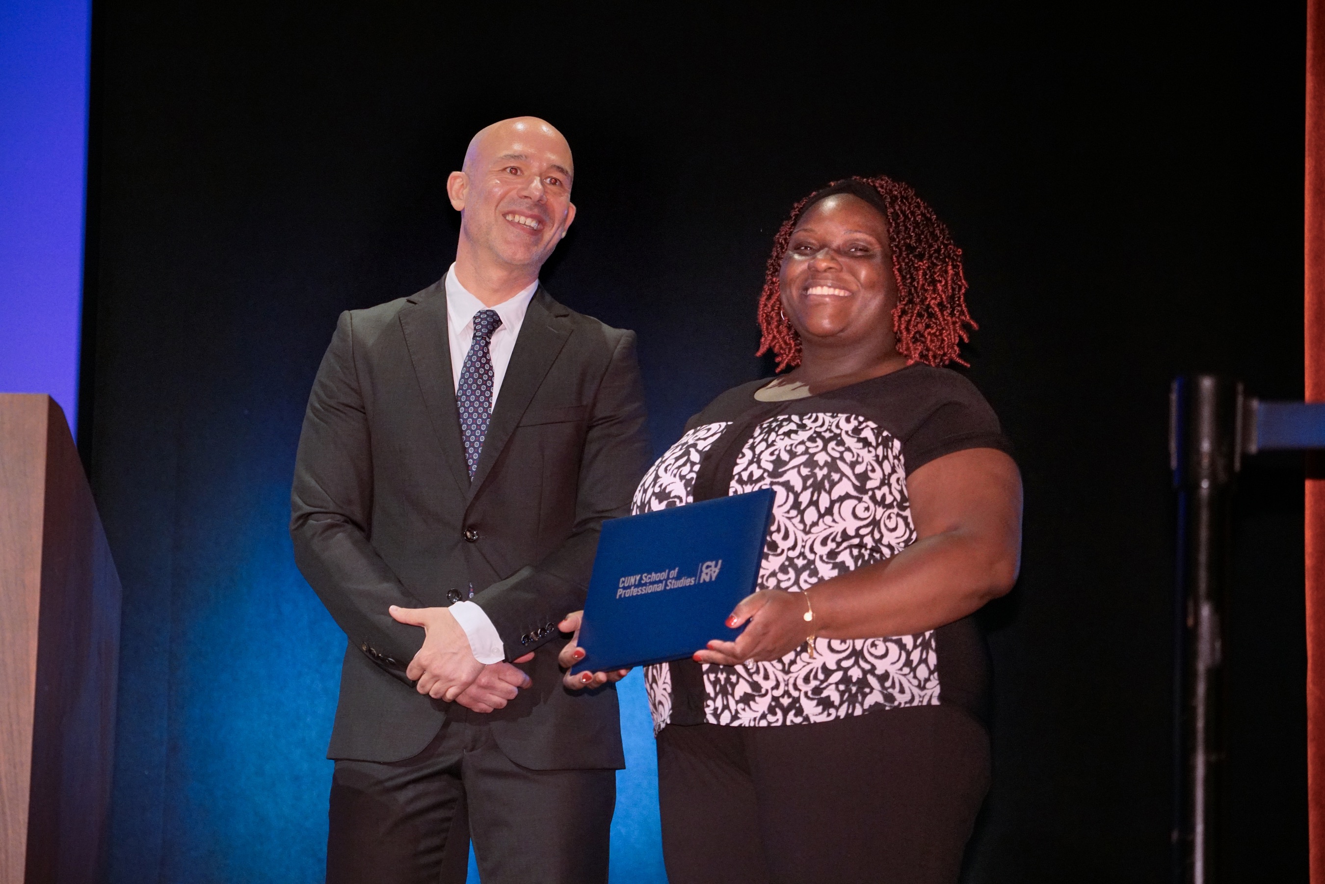 CUNY SPS student being presented with an award.