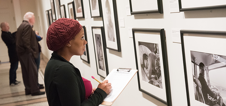 Woman with clipboard in a gallery at the New-York Historical Society