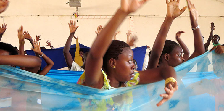 People dancing with hands held in the air