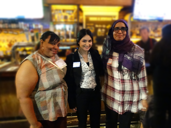 Three women posing together at networking reception venue