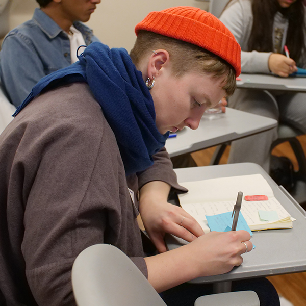 CUNY SPS student working at a desk.