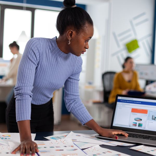 african-woman-scorlling-on-laptop-looking-at-chart