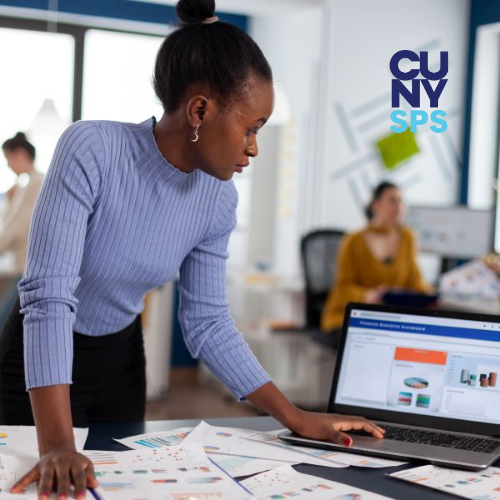 african-woman-scrolling-on-laptop-looking-at-chart