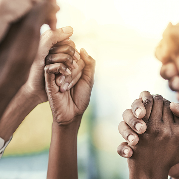 Cropped shot of a group of businesspeople holding their hands in solidarity