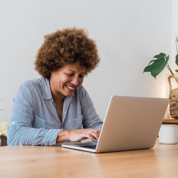 happy-african-mature-woman-using-laptop-computer