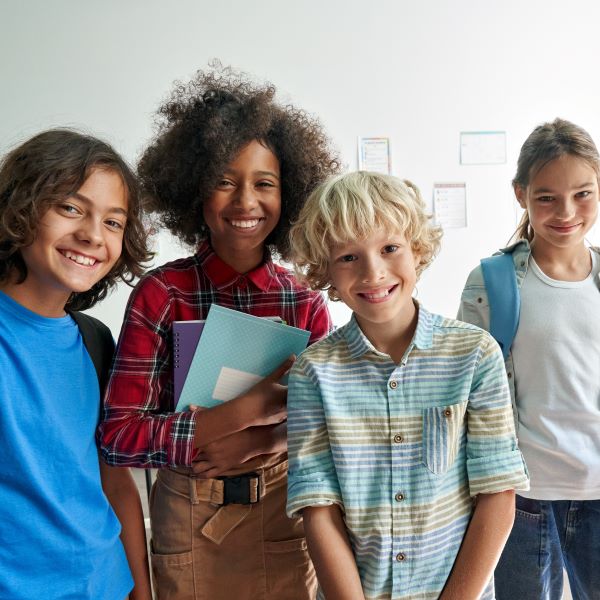 Group of diverse junior school students smiling