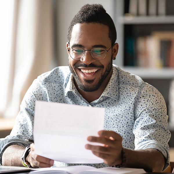 Happy student reading scholarship acceptance letter