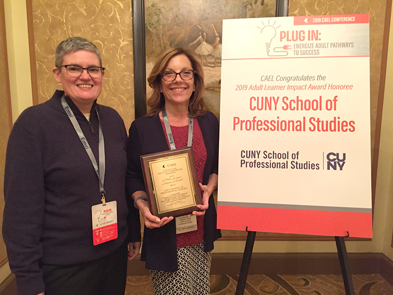 Dr. Jennifer Sparrow holding Adult Learner Impact Award reward accompanied by Holli Broadfoot.