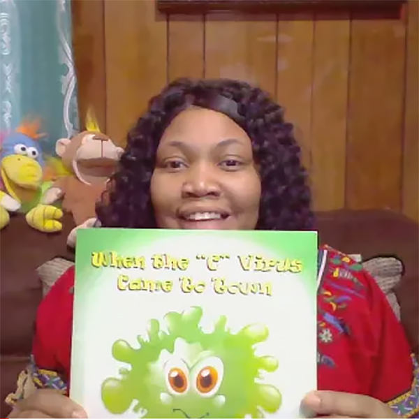 Kadeatrice holding children's book