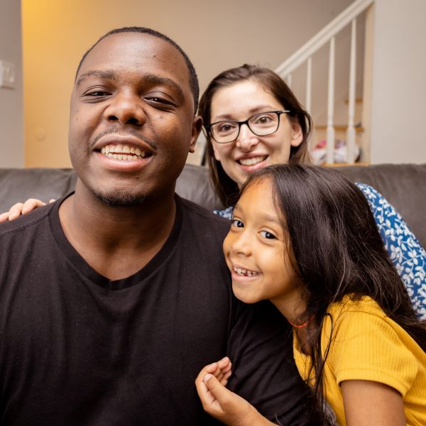 Diverse family with one daughter smiling for the camera