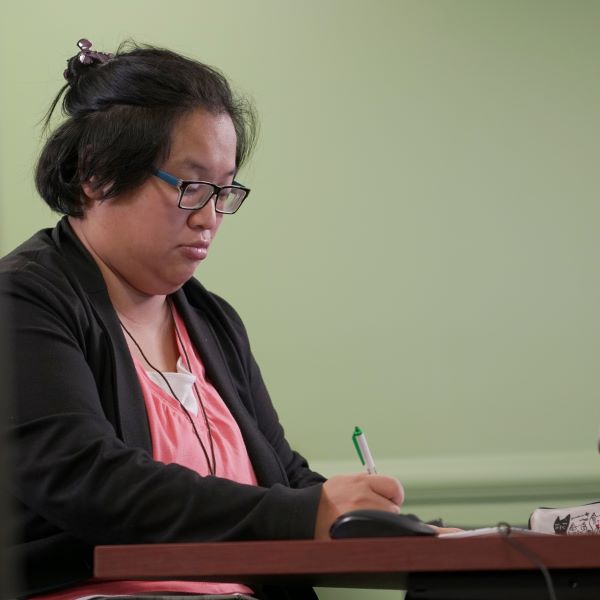 CUNY SPS female student works at her desk.