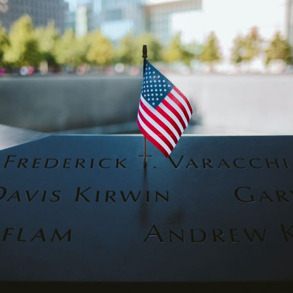 Close-up of American Flag Placed on 9/11 Memorial Plaque of Names