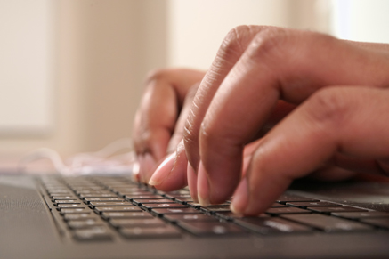 Woman typing on laptop