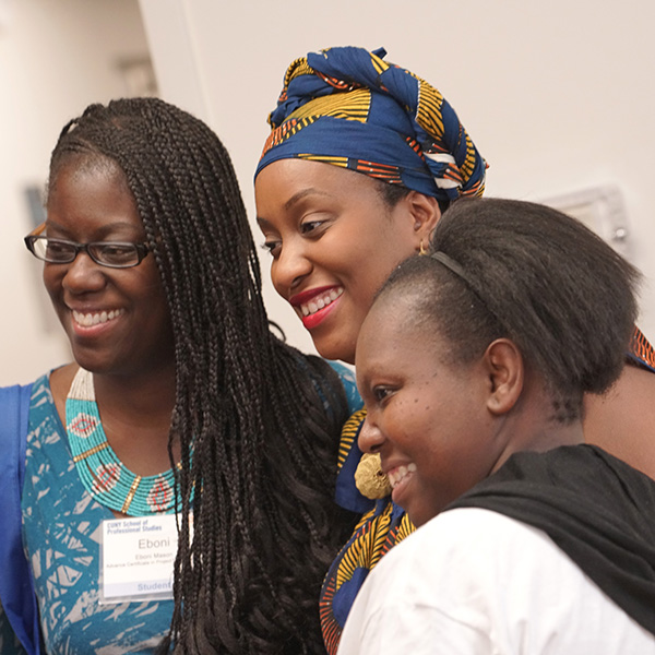 Three African American female students taking group photo at on-campus event