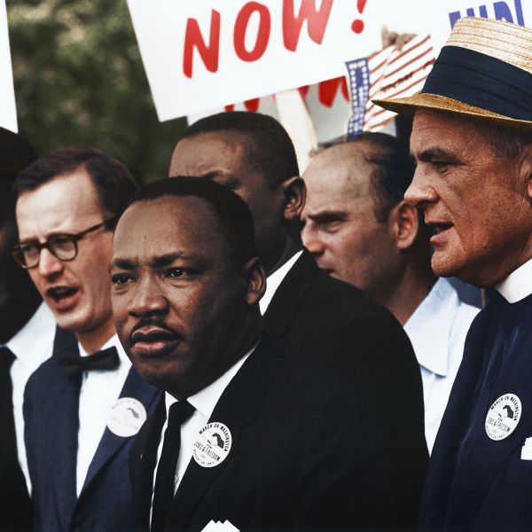 Martin Luther King Jr. standing in crowd during protest