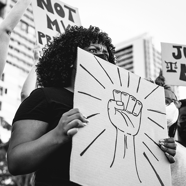 African American woman holding Black Lives Matter sign at public demonstration