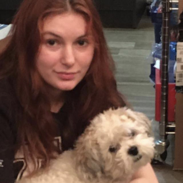Photo of Rhea LaFleur with a small white dog