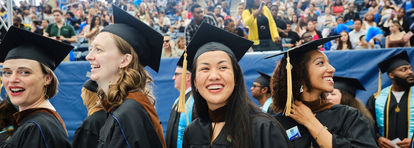 Students smiling CUNY SPS Commencement