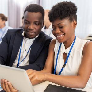 Adult African American female and male having a discussion over a laptop