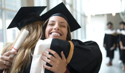 Graduating students in an congratulation embrace