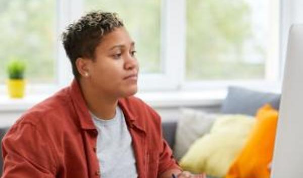 Photo of student looking at laptop