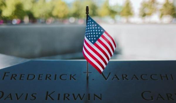 Close-up of American Flag Placed on 9/11 Memorial Plaque of Names