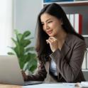 Asian American woman having discussion on laptop
