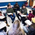 Group of students sitting in a classroom having a group discussion