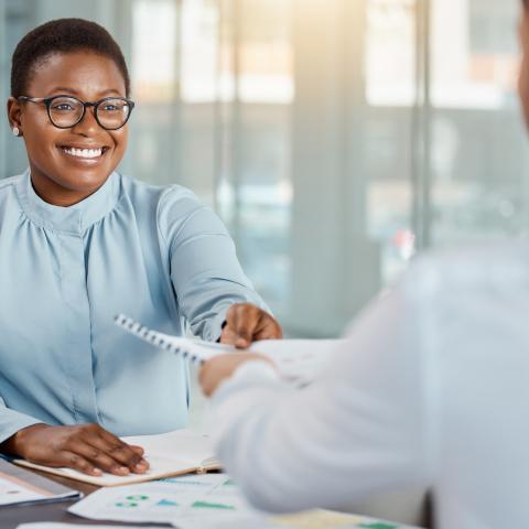 African American Female reviewing resume with Adult American Male