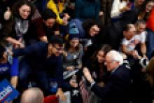 Group of young voters crowded around Presidential candidate Bernie Sanders
