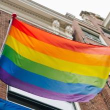 LGBTQIA+ Rainbow Flag Waving Outside of Building
