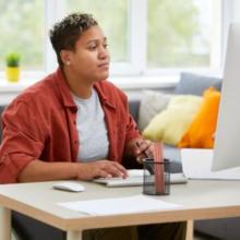 Photo of student looking at laptop