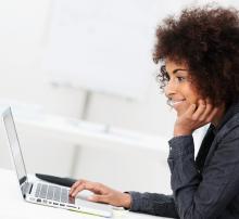 Woman sitting at desk working on laptop
