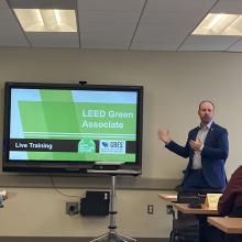 Male teacher presents LEED credential presentation slide in classroom