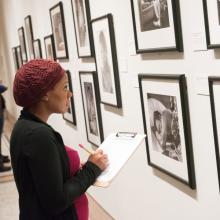 CUNY SPS Museum Studies Student Looking at Artwork in Museum