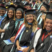 Graduates smiling at 2024 Commencement Ceremony