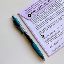 Voter registration card with pen