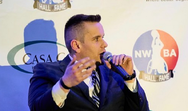 Ryan Martin, CUNY SPS alum and head of CUNY Inclusive and Adaptive Sports, speaking in front of an NWBA Hall of Fame background